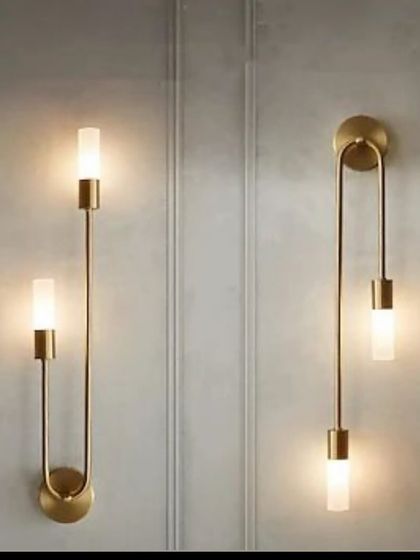 A pair of modern, minimalist wall sconces with a sleek U-shaped design. These are perfect for flanking a mirror, a bed, or a piece of art.