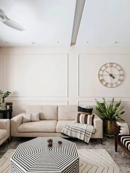 This shot highlights the geometric, black and white coffee table, which acts as the centerpiece of the living room. It's a bold choice that anchors the space and ties together the various seating elements.