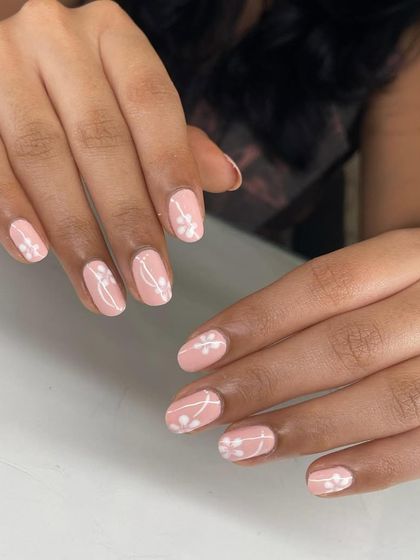 A minimalist botanical design featuring delicate white sprigs on a soft pink base. This look is clean, simple, and very chic.