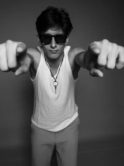 A fun and engaging black and white portrait with the model pointing at the camera. It's full of personality.