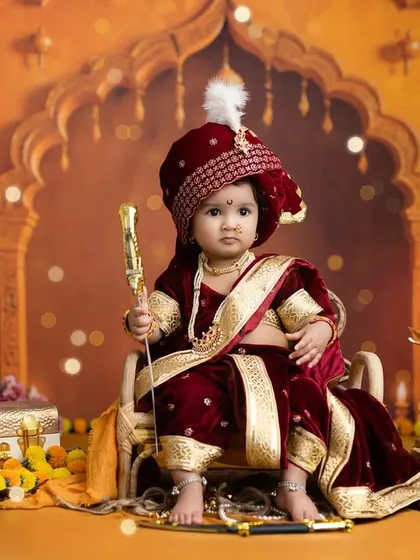 A portrait of a little girl in a royal Marathi peshwai dress, looking regal and serious for her 'Jijau-chi Lek' (Daughter of Jijabai) photoshoot.