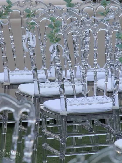 Elegant transparent 'ghost' chairs were used for guest seating, adding to the light and ethereal feel of the all-white theme.