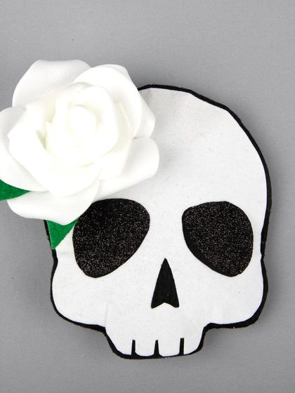 A clean product shot of the skull and rose hair clip.