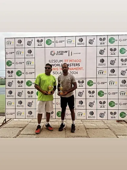 With my doubles partner and our trophies at the ITF MT400 in Solapur.