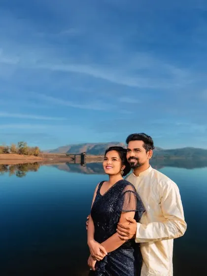 A serene and expansive shot against a calm lake, reflecting the beautiful blue sky. This kind of landscape provides a peaceful and epic backdrop for a couple's portrait, highlighting their connection amidst nature.