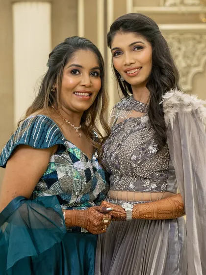 A beautiful mother-daughter duo at an engagement party, both adorned with my henna designs.