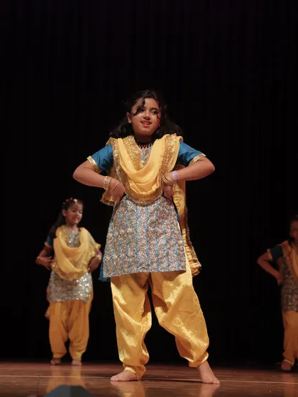 Our 'Dancing Divaas' troupe showcases grace and energy in this folk dance performance. We train our students in various styles, ensuring they are versatile and expressive performers.