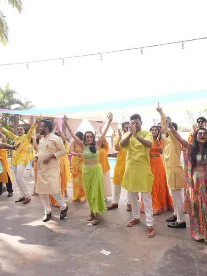 Leading the dance moves at a poolside party. My job is to get everyone on their feet and enjoying the celebration under the sun.