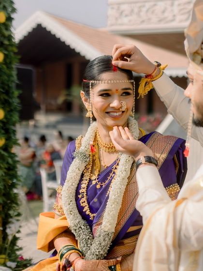 A beautiful ritual during a Maharashtrian wedding, the bride's smile is everything.