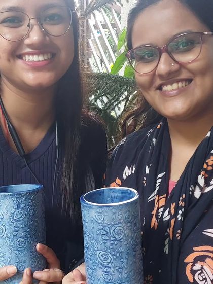The best part of teaching is seeing the proud smiles when students collect their finished pieces after firing. These two created beautiful blue floral vases, and the vibrant color that emerged from the kiln was a wonderful surprise for them.