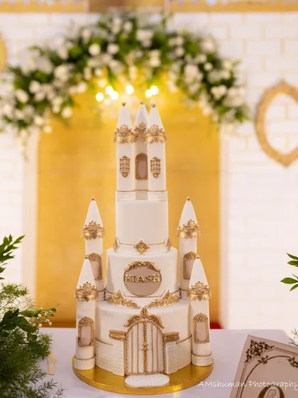 The centerpiece of a fairytale party. This magnificent castle cake, detailed with gold accents, was custom-designed to perfectly match the royal theme of a first birthday celebration.
