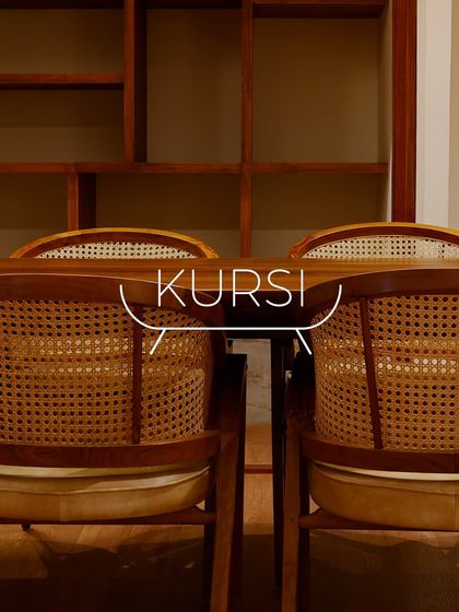 A set of my 'Modis' dining chairs with their distinctive curved rattan backs, paired with a solid teak table. This combination creates a warm, inviting atmosphere.