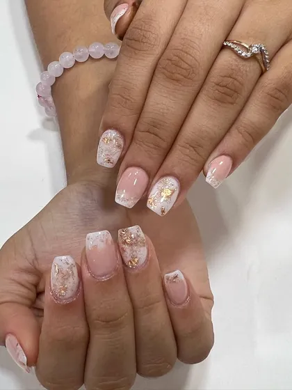 This is an acrylic ombre set with encapsulated gold foils and glitter. This technique places the decorative elements inside the acrylic, creating a smooth, durable, and multi-dimensional look.