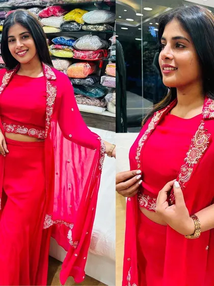 This vibrant pink Indo-Western set features a crop top, palazzo pants, and a beautifully embroidered cape.