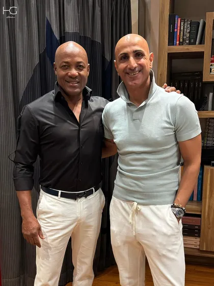 It was an honor to dress the legendary cricketer Brian Lara. This look, featuring a sharp black shirt and crisp white trousers, is a testament to how I tailor style for champions.