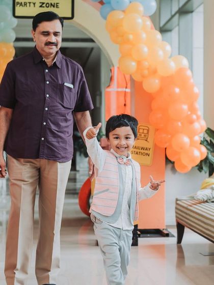 The birthday boy looking excited as he arrives at his party with his grandfather. Capturing these family moments is so important.