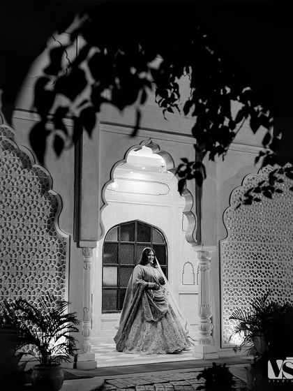 The same scene in black and white, which transforms the portrait into a timeless piece of art. The monochrome tones emphasize the textures, shadows, and Sonal's elegant silhouette.