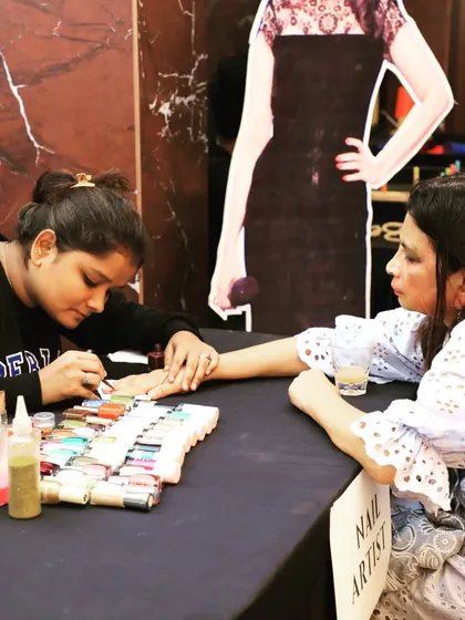 We incorporate interactive entertainment stations like this nail art booth for corporate get-togethers. These activities provide a fun and engaging experience for guests and their families during the event.