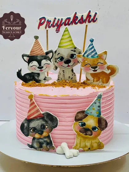 A pet theme cake decorated with cute, cartoonish dogs wearing party hats. This cake was inspired by a Pinterest idea and is perfect for any dog lover.