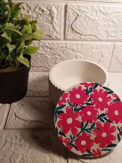 Our accessory jar with a hand-painted floral lid. This is a limited stock item, perfect for adding a touch of artistry to your storage.