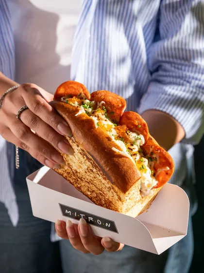 A delicious pepperoni sandwich made with fresh brioche bread. The focus is on the generous filling and the soft texture of the bun.