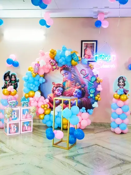For a truly special and blessed baby shower, I designed this unique Kanha ji theme. It combines traditional elements with modern decor, featuring a custom backdrop of Lord Krishna, a neon "Baby Shower" sign, and a beautiful pink and blue balloon ring.
