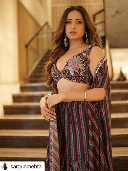 A beautiful haircut and caramel balayage for actress Sargun Mehta. The face-framing layers and soft waves are perfect for this festive, traditional look.