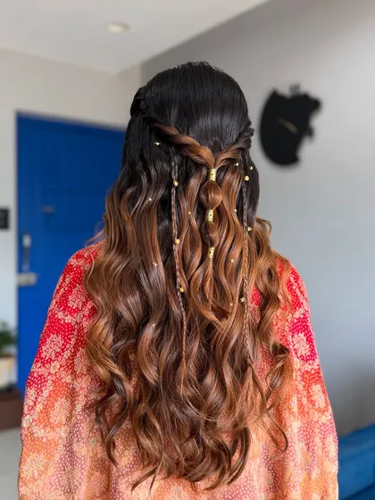 A detailed shot of the beautiful, bohemian-inspired hairstyle with soft waves and delicate braids.