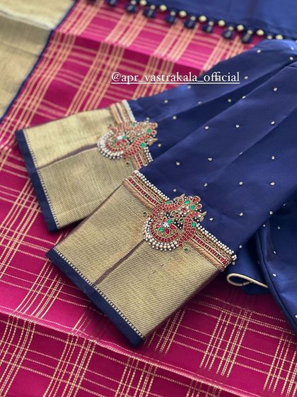 Another navy blue blouse design, this one with statement motifs on the sleeves.
