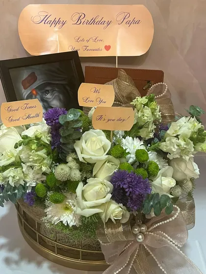 A clear shot of the 'Happy Birthday Papa' hamper, showcasing the beautiful combination of spiritual elements and fresh blooms.