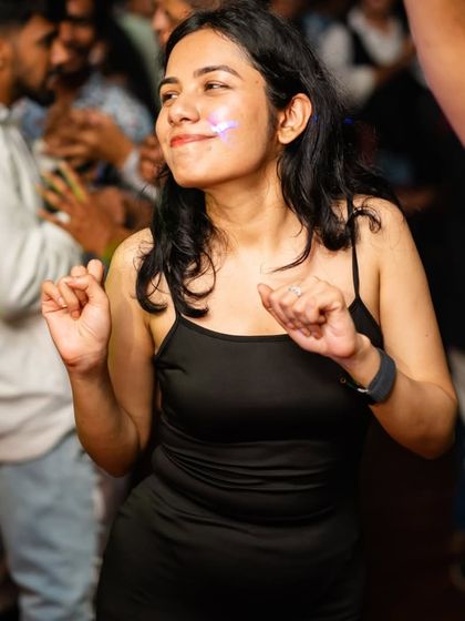 A partygoer lost in the music, feeling the beat. This is what a great DJ night is all about.