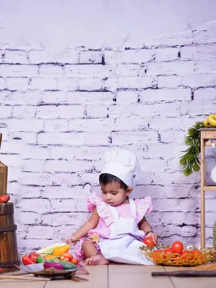A little chef carefully inspecting the ingredients. Themed studio shoots like this allow for wonderful storytelling and capture your child's curiosity.