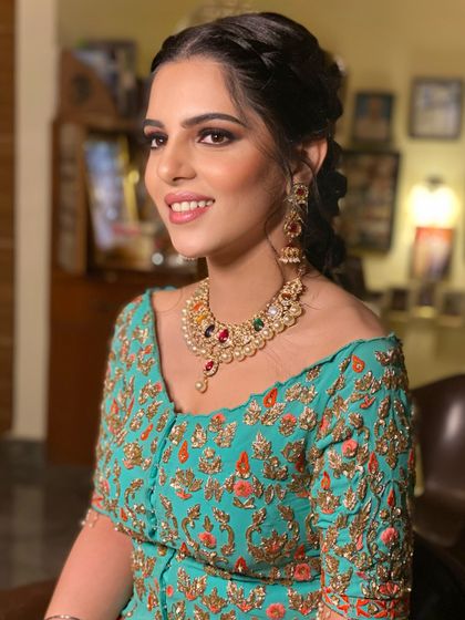 A beautiful Mehendi look in shades of teal. I created a soft smokey eye and a braided hairstyle to give her a chic and elegant vibe.