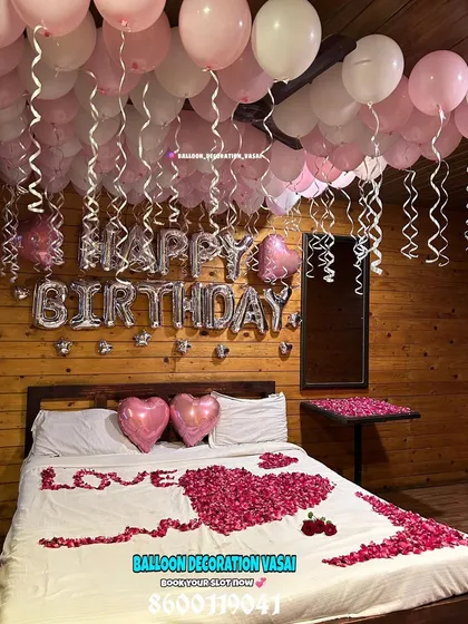 We also create romantic birthday surprises. This cozy room decoration features a "Happy Birthday" foil balloon banner, heart-shaped balloons, and rose petals on the bed to make your loved one's day extra special.