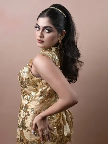 A confident pose showing how the makeup and hair come together to create a powerful, high-fashion look.