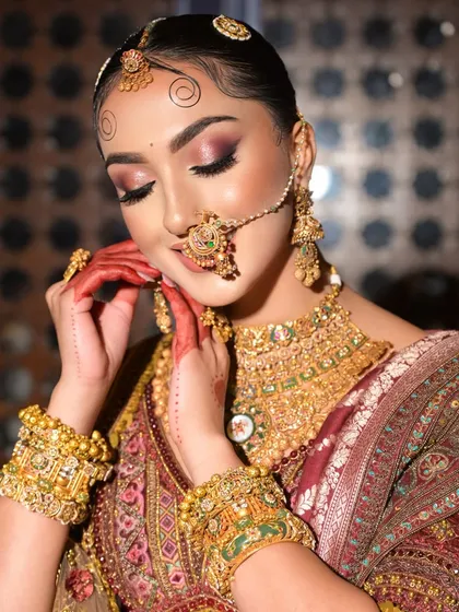 A vision dipped in royalty. This close-up shows the beautiful harmony between the soft, romantic eye makeup and the intricate details of the traditional jewelry.