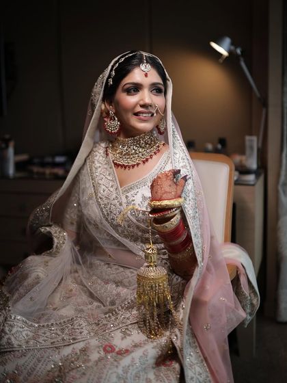 A classic bridal portrait. The lighting is dramatic, but her makeup remains soft and glowing.