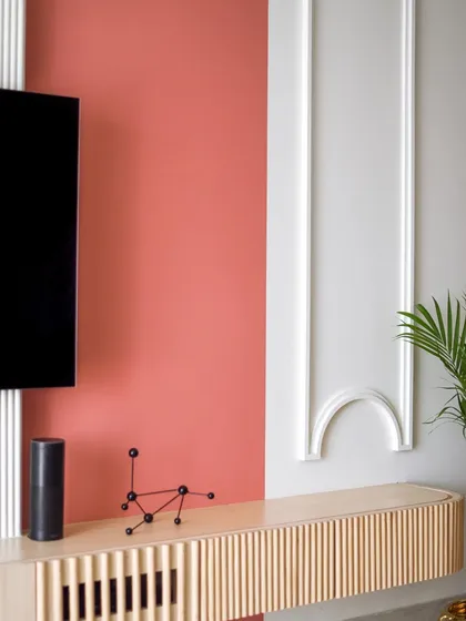 The TV wall features classic moulding details, adding a touch of elegance to the modern design.