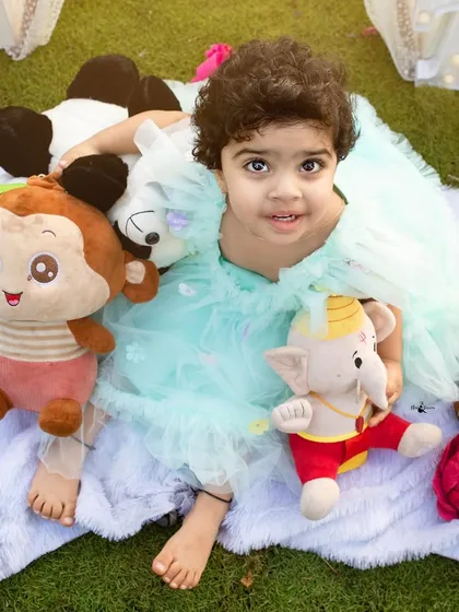 A sweet cuddle with all her favorite stuffed animals. These personal touches make a birthday photoshoot even more special and memorable.