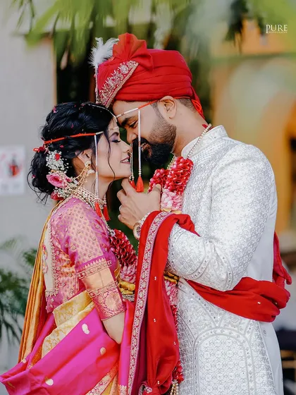A romantic close-up of the couple on their wedding day. The groom's touch and the bride's loving gaze make this a perfect portrait.