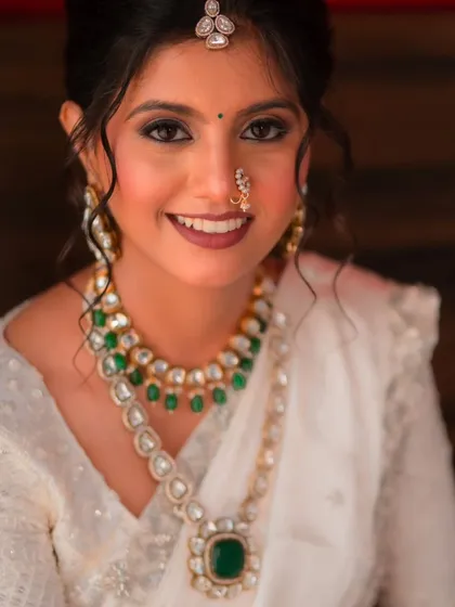 A classic bridal portrait. Her eyes are the focus, defined with liner and mascara, while the rest of her makeup remains soft and neutral, letting her natural beauty shine.