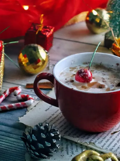Another angle of the Christmas coffee setup, focusing on the details like the candy cane heart and miniature presents.