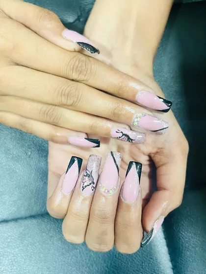 A chic set with black French tips and delicate, hand-painted butterfly wing art.