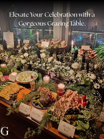 Elevate your celebration with a gorgeous grazing table. This stunning, candlelit spread is a perfect example of how we turn moments into memories with our artfully arranged feasts.
