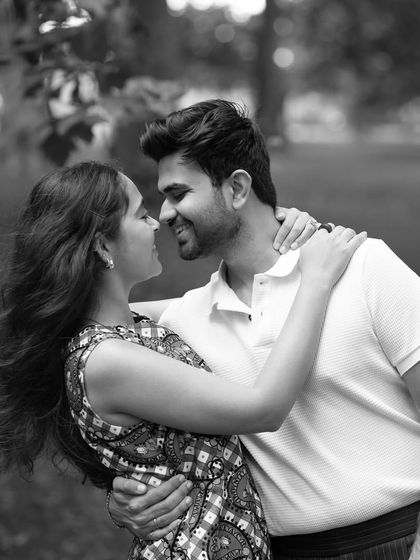 A beautiful black and white portrait of the couple sharing a loving gaze in the park. The soft focus and natural setting create a timeless and romantic feel.