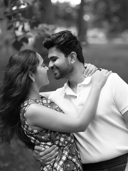 A beautiful black and white portrait of the couple sharing a loving gaze in the park. The soft focus and natural setting create a timeless and romantic feel.