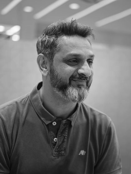 Tailored to perfection. A black and white portrait of a happy client after receiving a classic, well-groomed haircut.