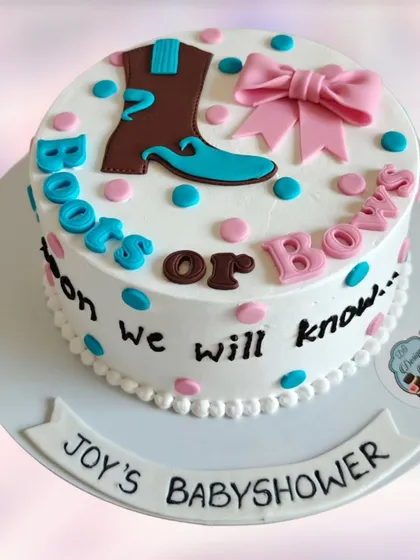 A "Boots or Bows" themed gender reveal cake. This is a fun and unique twist on the traditional pink and blue theme, perfect for a rustic or western-style baby shower.