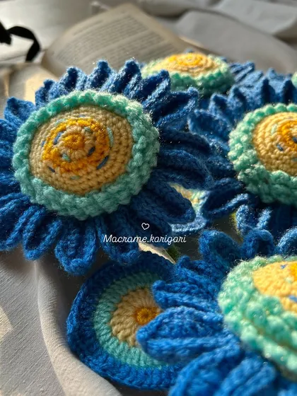An artistic close-up of the layered petals and textured centers of our blue crochet sunflowers. It's art in thread form.