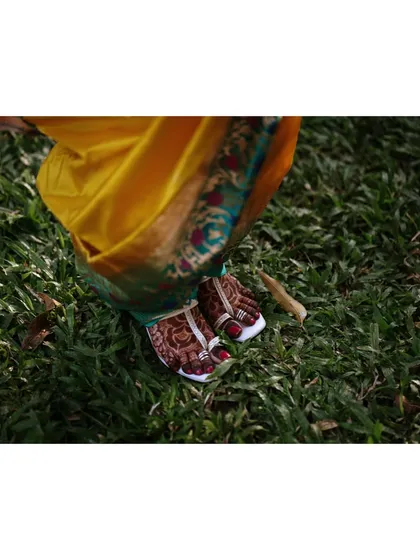 A detail shot of the bride's feet, adorned with henna and traditional toe rings. We capture these details to preserve the full picture of the bridal look.
